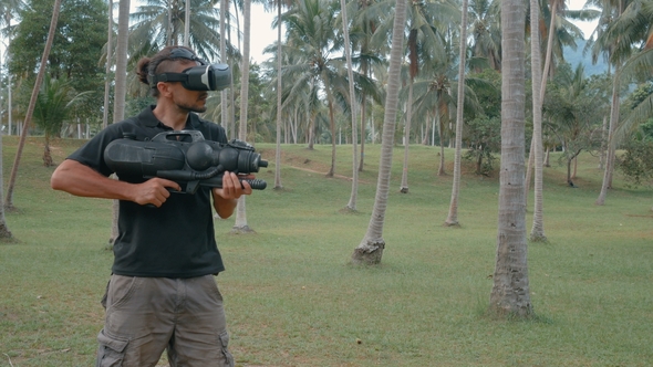 Man with Weapon Playing Virtual Reality Game in the Jungle