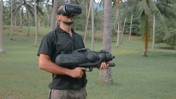 Man with Weapon Playing Virtual Reality Game in the Jungle