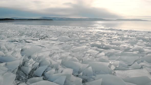 The Northern Landscape of a Frozen Lake or River. Shards of Ice Near the Shore, in the Distance