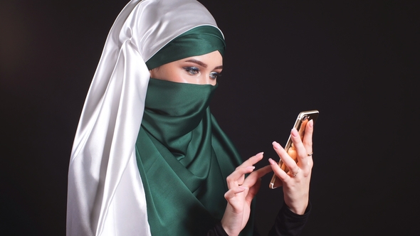 Portrait of Beautiful Arabic Muslim Girl Using Mobile Phone