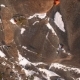 Aerial View of a Rock Climber Climbing a Steep Cliffs During a Sunny Winter Day. - VideoHive Item for Sale