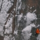 Aerial View of a Rock Climber Climbing a Steep Cliffs During a Sunny Winter Day - VideoHive Item for Sale