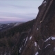 Aerial View of a Rock Climber Climbing a Steep Cliffs during a Sunny Winter Day - VideoHive Item for Sale