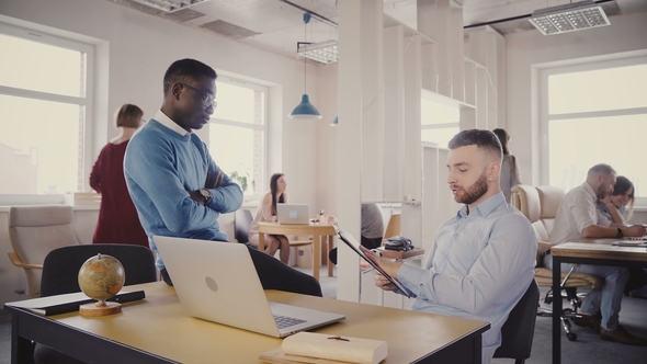 Caucasian Female Boss Helping Young Multiethnic Colleagues. Woman Manager Motivates Employees in