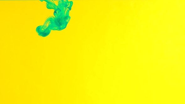 Ink in Water. Green Paint on Yellow Reacting in Water Creating Abstract Cloud formations alt