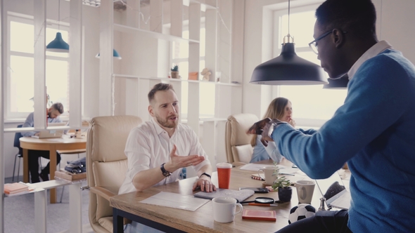 Mixed Ethnicity Friends Chat in Trendy Coworking. Young Happy Male Colleagues Enjoying Healthy