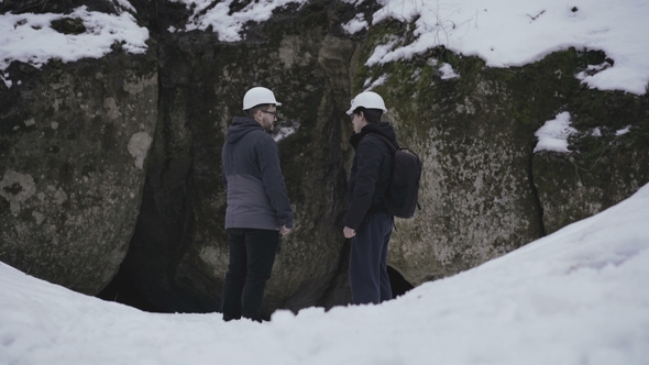 Two Speleologists Come To Enter of the Cave in Forest