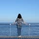 Woman Standing on Wooden Pier Looking into the Distance - VideoHive Item for Sale