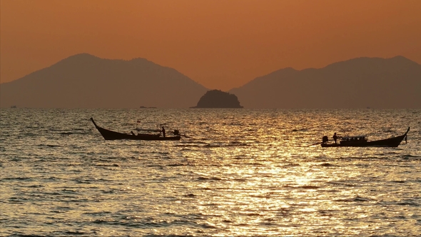 Longtail Boats Silhouettes on Sea at Sunset
