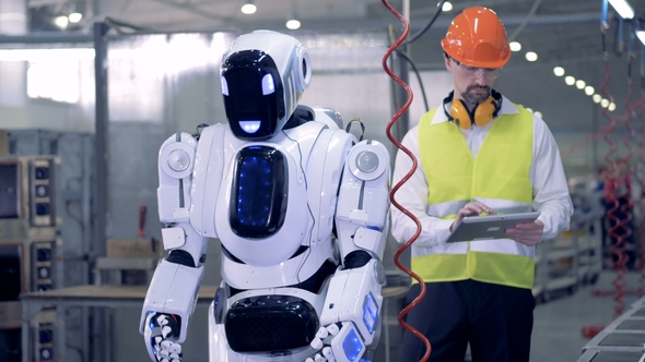 Human-like Robot Starts Working with a Drill After a Corresponding Command From a Factory Worker
