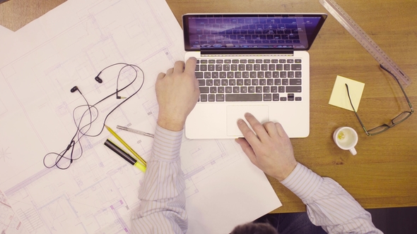 Male Hands on Keyboard of Laptop