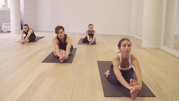 People Doing Yoga Exercises on Yoga Class