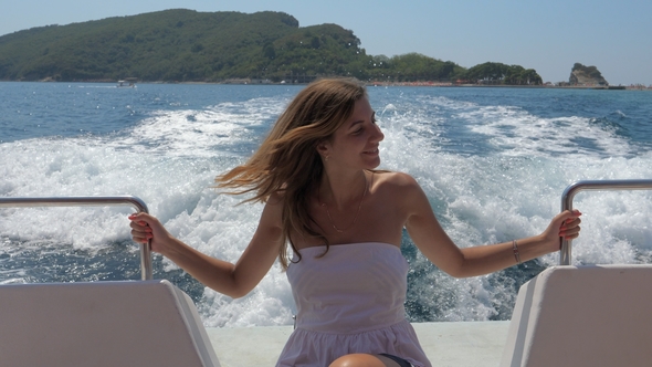 A Pretty Young Woman Sitting In A Floating Boat At Sea