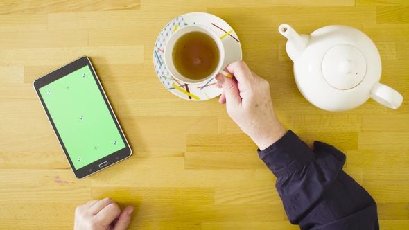 Female Hands Scrolling a Tablet with Green Screen