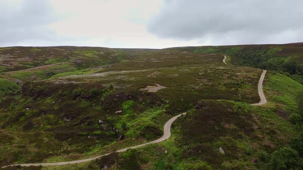Drone ariel point of view.  Derbyshire Peak District moorlands with winding pathways.