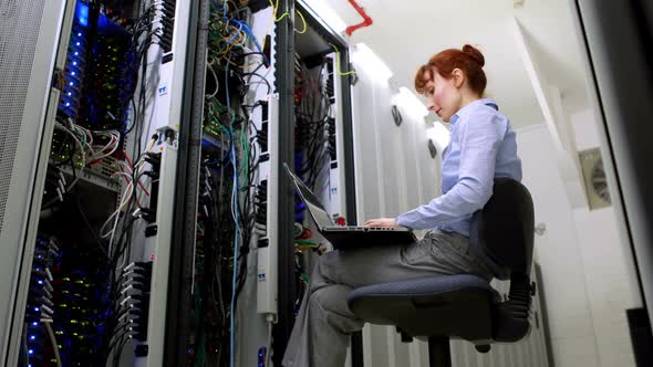 Technician working beside open server