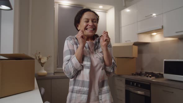 Human Hand Giving Keys From New Apartment to Adult Woman Indoors