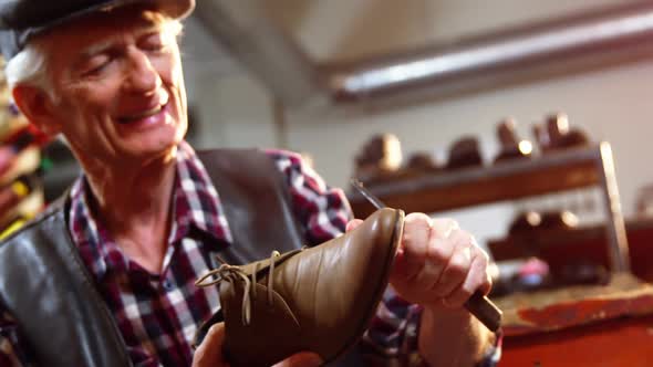 Shoemaker repairing a shoe