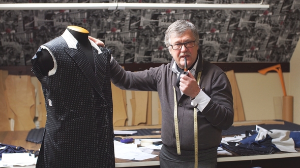 Professional Mature Tailor Working on His New Classical Suit Using Tailor's Dummy at His Workshop