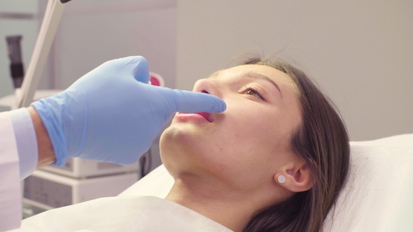 Doctor Wiping Solution from the Patient's Lips