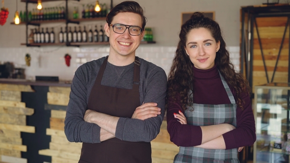 Portrait of Two Coffee House Owners Attractive Young People Standing Inside Coffee-shop, Smiling and