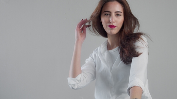 Portrait of Youn Woman Model in Studio with Blowing Hair