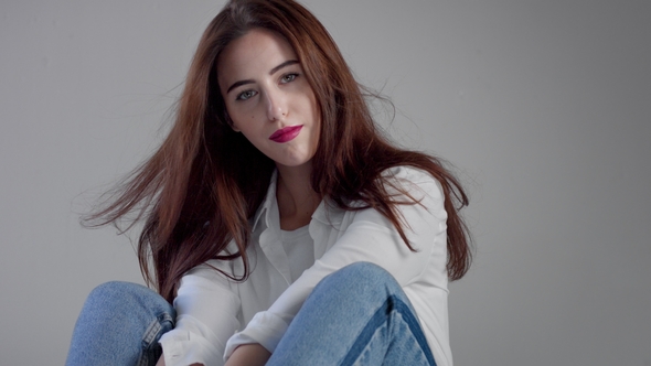 Woman in Industrial Studio Wears Jeans and White Shirt