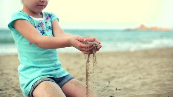 Little Girl on the Beach, Happy Little Baby Playing with Sand on the Beach. A Child, a Child