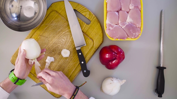 Chef Cooking a Chicken Dish. Cutting Onion