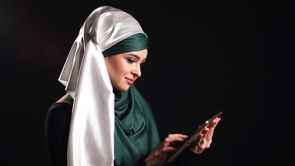 Portrait of Beautiful Arabic Muslim Girl Using Mobile Phone.