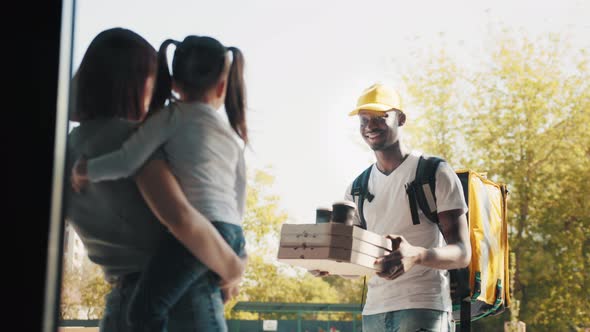 Food Delivery Courier Delivers Lunch to a Beautiful Girl with a Baby