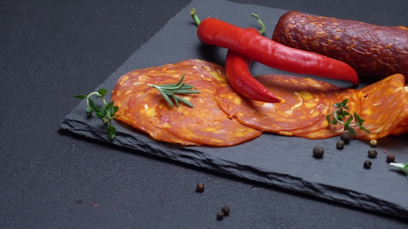 Salami and Chorizo Sausage  on Dark Concrete Background