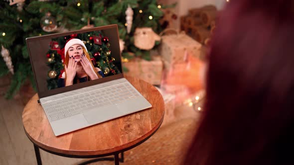 Two Girlfriends Celebrate Christmas with Video Call Using Laptop Social Distance