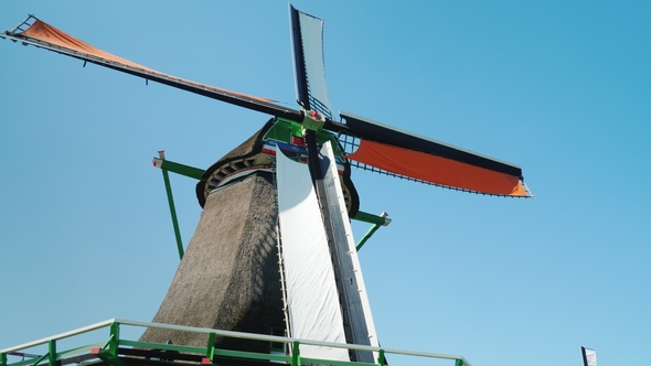 An Old Dutch Windmill. Against the Background of the Blue Sky
