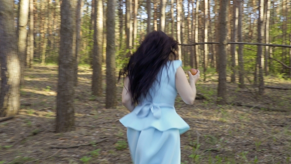 Beautiful Woman in Blue Dress Running in the Forest