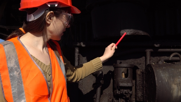 A Worker Checks of the Hydraulic System of a Career Excavator