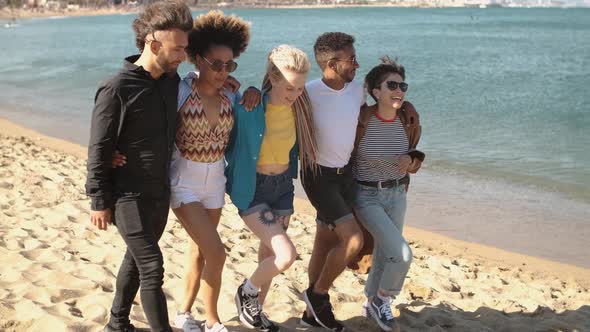 Trendy Young Friends Strolling on Beach 