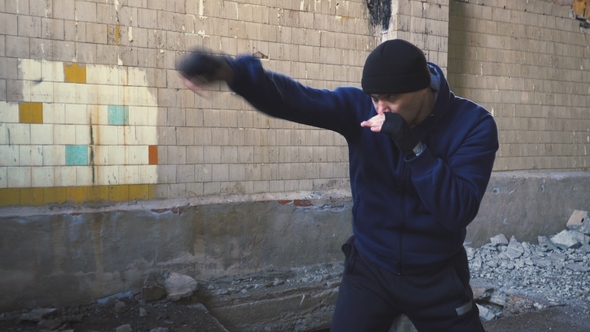 A Boxer Trains in an Abandoned Building.