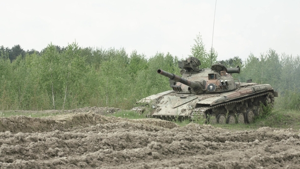 Military Tank in Movement on a Dirt Ground Terrain