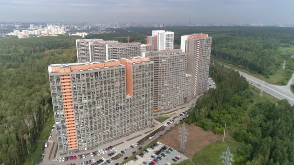 Aerial drone shot of apartment buildings next to the highway 05