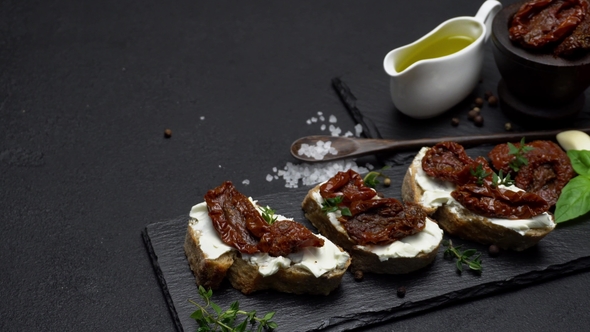 Bruschetta with Canned Sundried or Dried Tomato Halves on Stone Serving Board