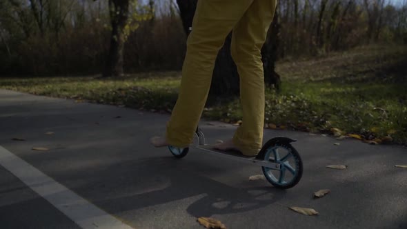 Barefoot man riding scooter in public playground, Zagreb, Croatia.