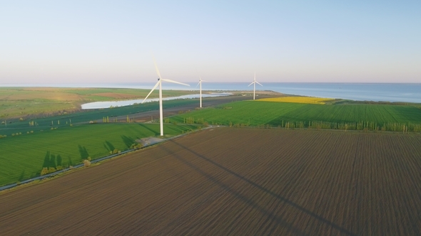 Wind Turbines and Agricultural Fields - Energy Production with Clean and Renewable Energy - Aerial