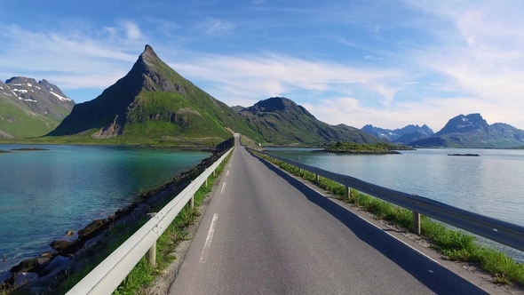 Driving a Car on a Road in Norway Lofoten