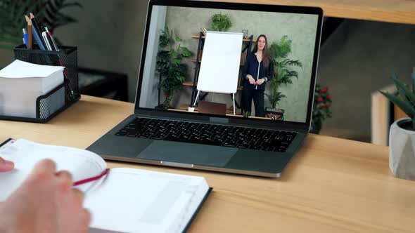 Woman Teacher in Computer Screen Greets Tells Teaches Remote Video Call Laptop