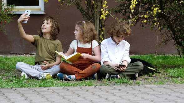 Girl Wants to Read the Book while Boys Are Busy with Their Smartphones