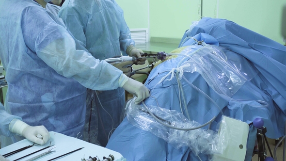 Two Doctors and Nurse During Laparoscopic Surgery