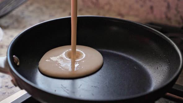 Pouring Pancake Mixture on a Pan