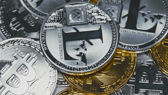 Golden, Silver Bitcoins and Litecoins Revolving on Bills of 100 Dollars