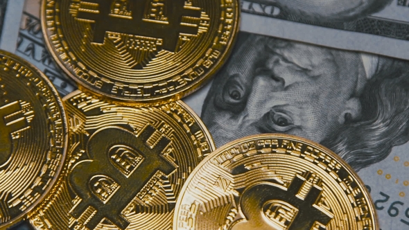 Golden Bitcoins Revolving on Bills of 100 Dollars